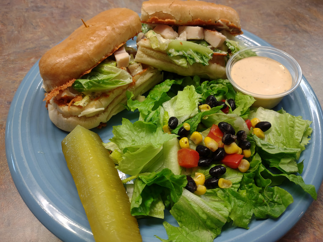 Freshly plated Caesar chicken sandwich at Fine Thyme Café